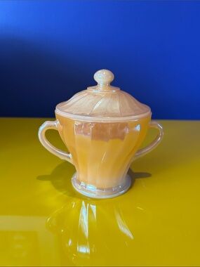 Fire King Peach Lustre sugar bowl with lid in Swirl pattern.